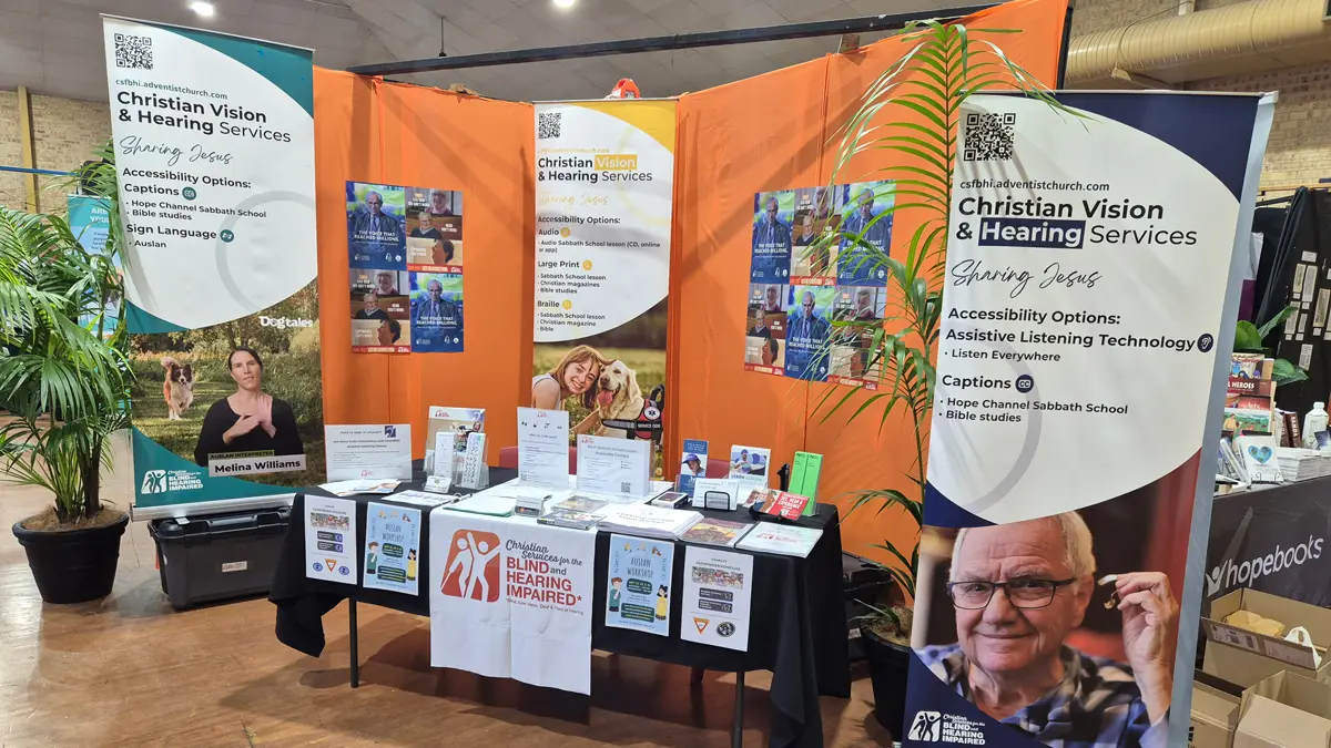 The CVHS booth at the conference, featuring a table with print resources behind which are pull-up banners