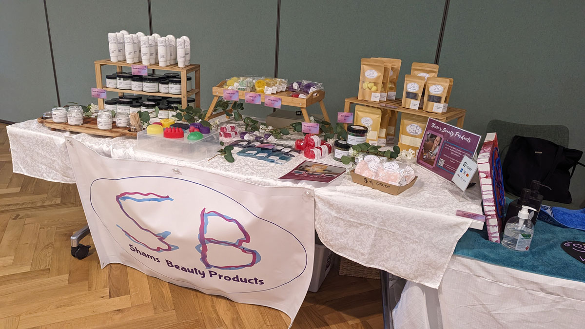 Market stall table with an assortment of different beauty products in tubs and tubes